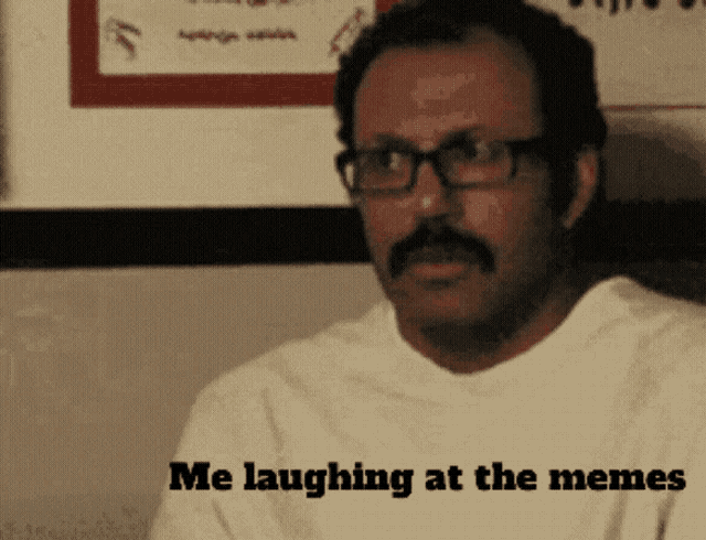 a man with glasses and a mustache says he is laughing at memes