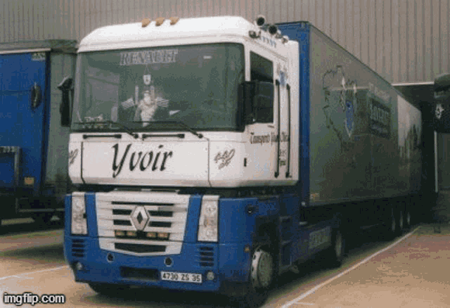 a blue and white truck that says yvoir on the front