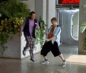 a man and a woman are dancing in a hallway in front of a red sign that says ' x '