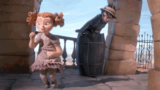 a girl in a pink dress is standing next to a man in a black suit