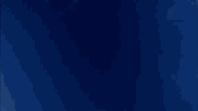a person is flying through a blue sky with the letter t on their pants