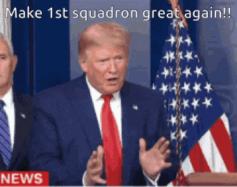 a man in a suit and tie stands in front of an american flag and says make 1st squadron great again .