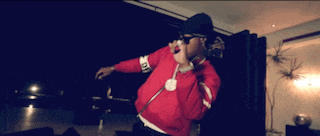 a man wearing a red jacket with the word army on the sleeve