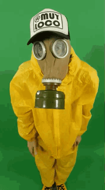 a person wearing a gas mask and a hat with muy loco on it