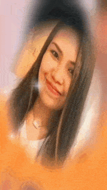 a woman with long hair is smiling for the camera .
