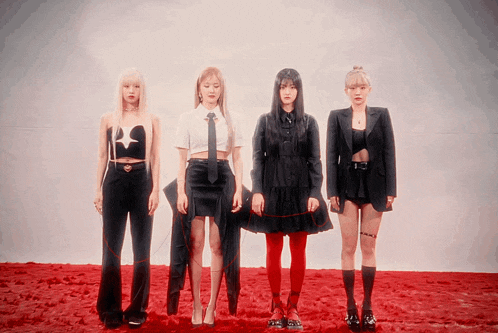 a group of four women standing next to each other