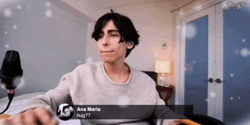 a young man sitting in front of a microphone with a message from ana maria asking him to hug
