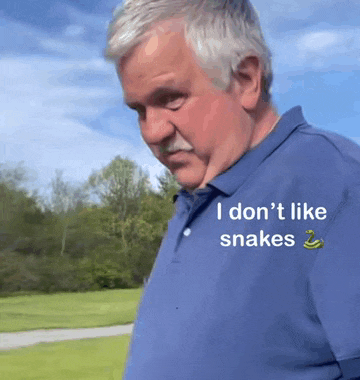 a man wearing a blue shirt that says i don t like snakes