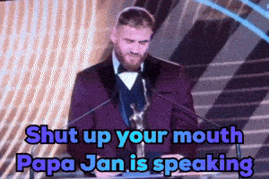 a man in a purple suit is giving a speech and the words shut up your mouth papa jan is speaking