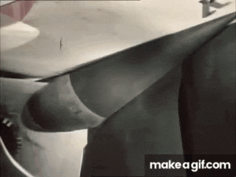 a black and white photo of a person holding a surfboard in their hands .