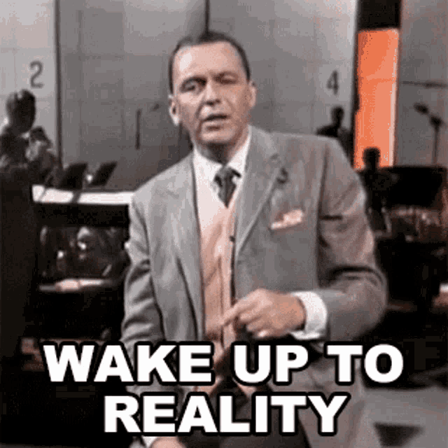 a man in a suit and tie is dancing and says wake up to reality