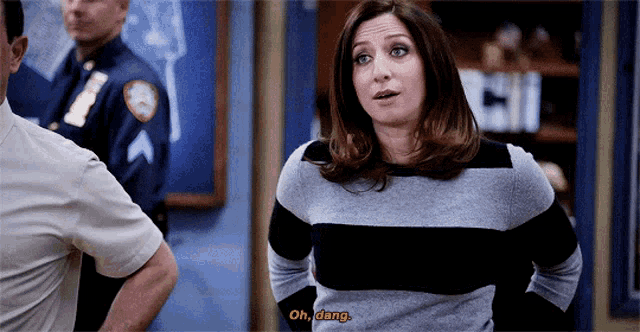a woman in a striped sweater says " oh dang " in front of a police officer