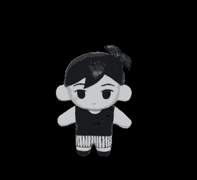 a stuffed toy of a boy with black hair and white clothes