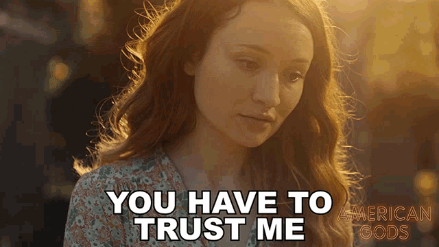 a woman says " you have to trust me " in front of a poster for american gods