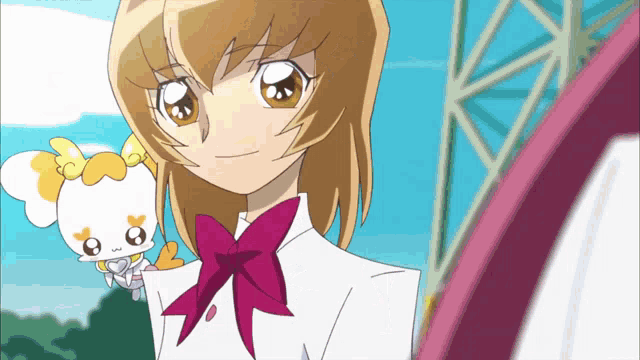a girl is holding a doll with a yellow bow