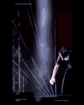 a man is standing on a stage with a microphone in his hand in front of a blue light .