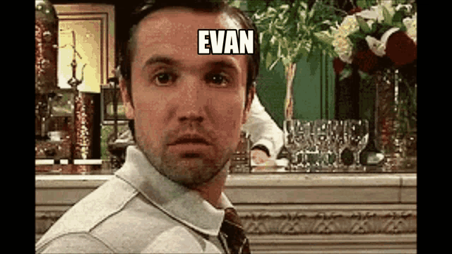 a man in a suit and tie is looking at the camera with a caption that says evan