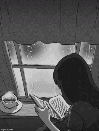 a girl is reading a book in front of a window with a cup of coffee