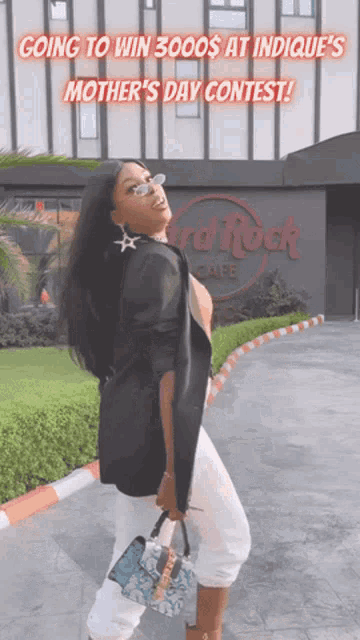 a woman is standing in front of a building that says hard rock cafe