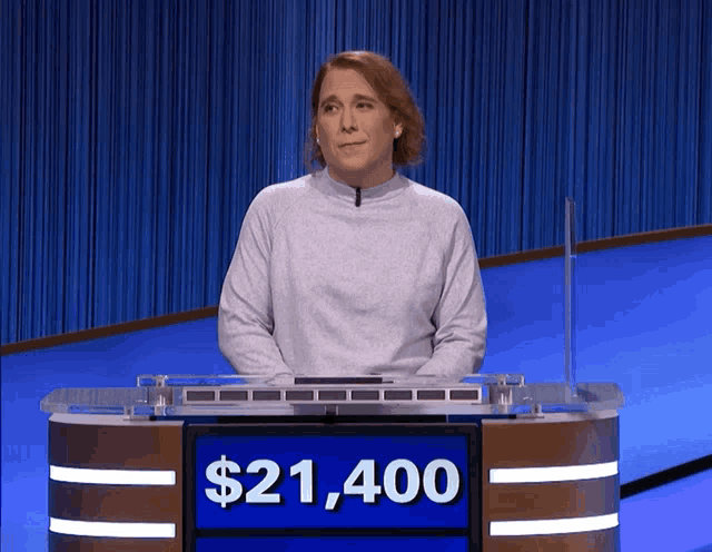 a woman stands in front of a podium that says $ 21,400