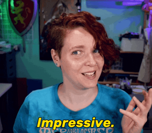 a woman wearing a blue shirt with the word impressive on it