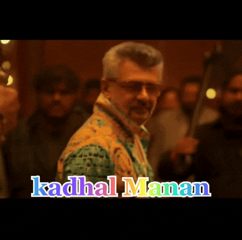a man holding a gun in front of a crowd with the words ' kadhal manam ' on it