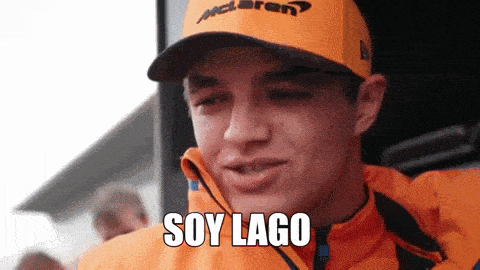 a man wearing an orange jacket and a mclaren hat says soy lago .