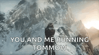a man is standing on top of a snowy mountain .