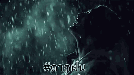 a person is standing in the rain with their head in the rain .