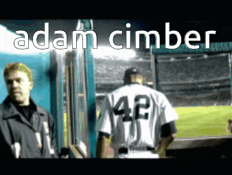 a baseball player with the number 42 on his back stands in the dugout