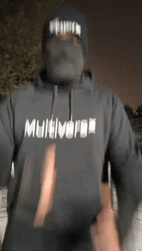 a man wearing a black hoodie that says multiverse on it