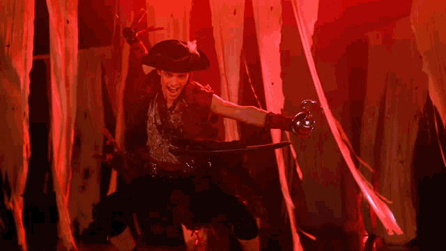 a man in a pirate costume holds a sword