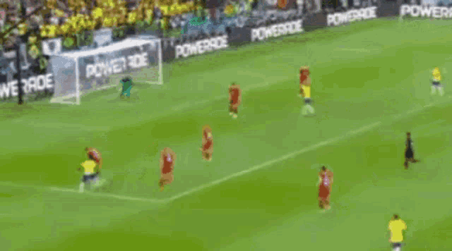 a soccer game is being played on a field with powerade advertisements