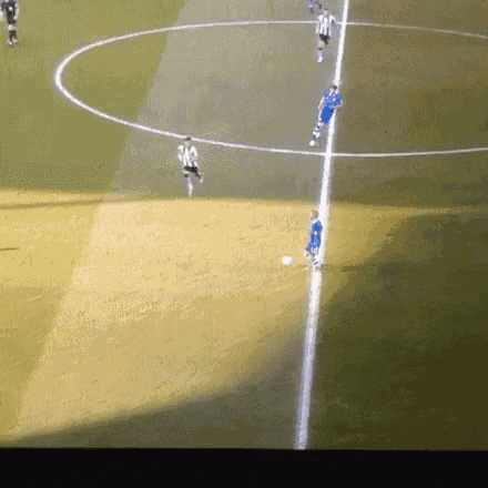 a group of soccer players are playing on a field with a white line