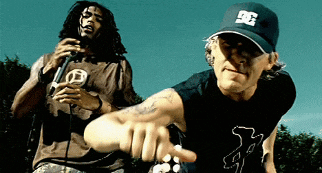 a man wearing a dc hat is pointing at another man