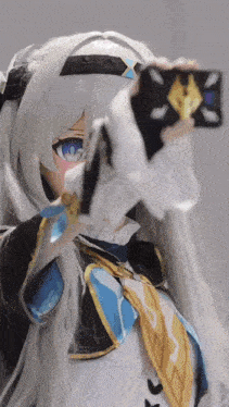 a doll with long white hair and blue eyes is taking a picture