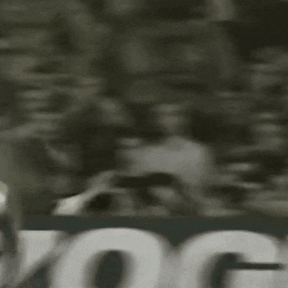 a soccer player wearing a number 9 jersey is kicking a soccer ball in the air .