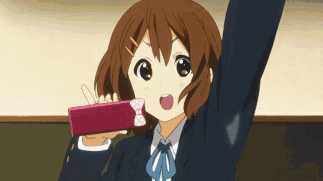 a girl with a bow on her hair is holding a pink box
