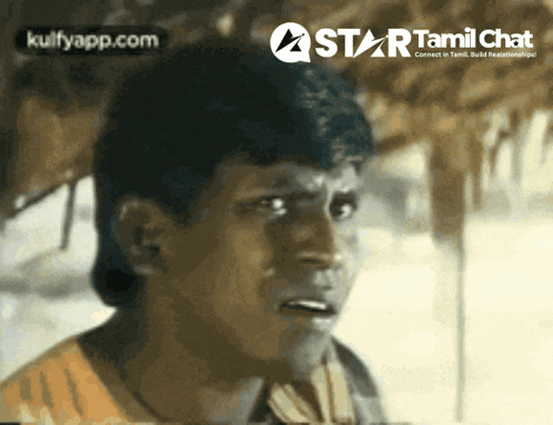 a close up of a man with a star tamil chat logo behind him