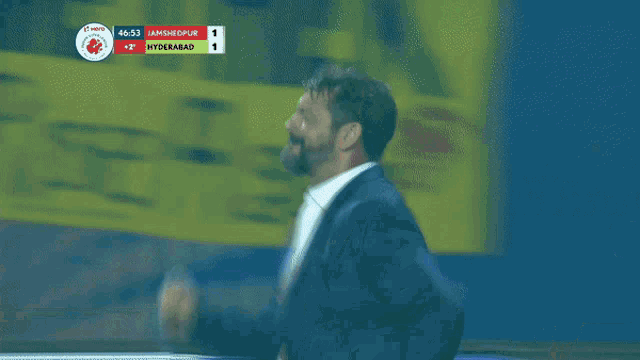 a blurred image of a man in a suit with a scoreboard that says hyderabad
