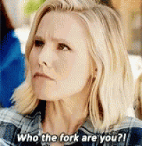 a woman is asking who the fork are you while wearing a plaid shirt .