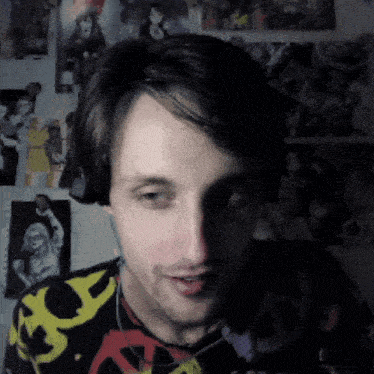 a man wearing headphones and a shirt with a yellow x on it