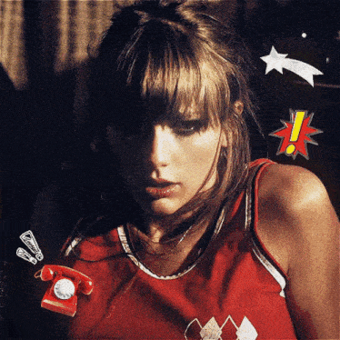 a woman wearing a red tank top has a red telephone pinned to her shirt