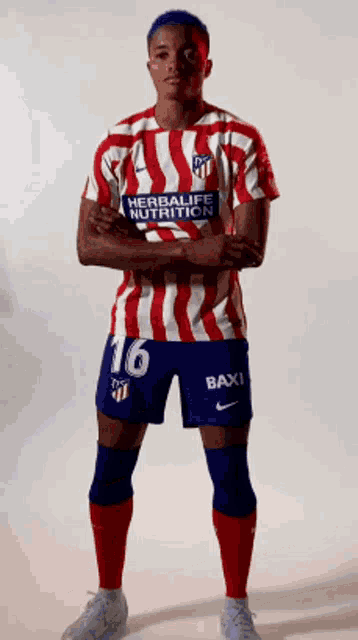 a soccer player wearing a red white and blue uniform with the number 16