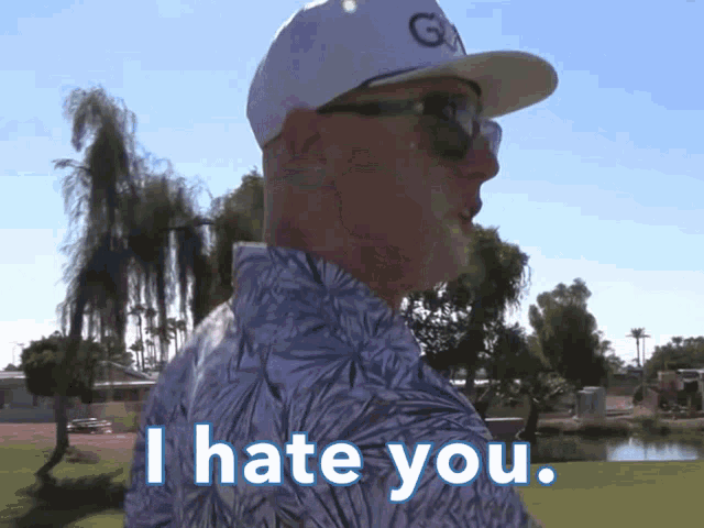 a man wearing a white hat and sunglasses says i hate you