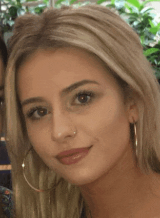 the woman is wearing hoop earrings and a nose ring .