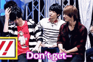 a group of young men are sitting in front of a sign that says " do n't get " on it