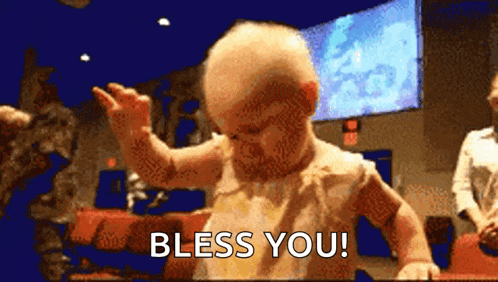 a baby is saying " bless you " while dancing