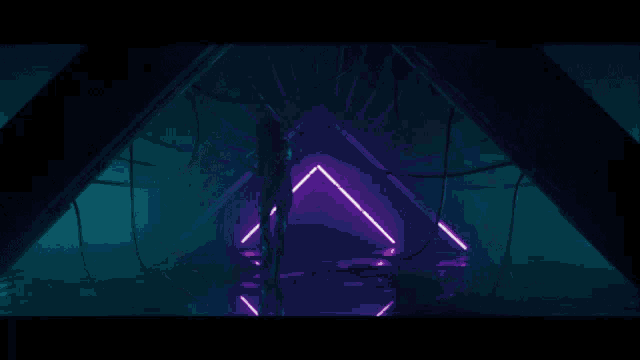 a woman in a bathing suit is standing in a dark room surrounded by neon lights