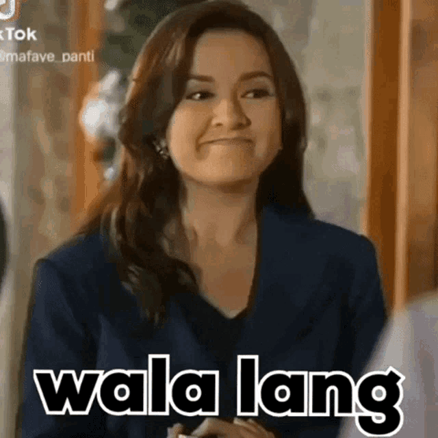 a woman is making a funny face with the words wala lang written on the bottom of her face .